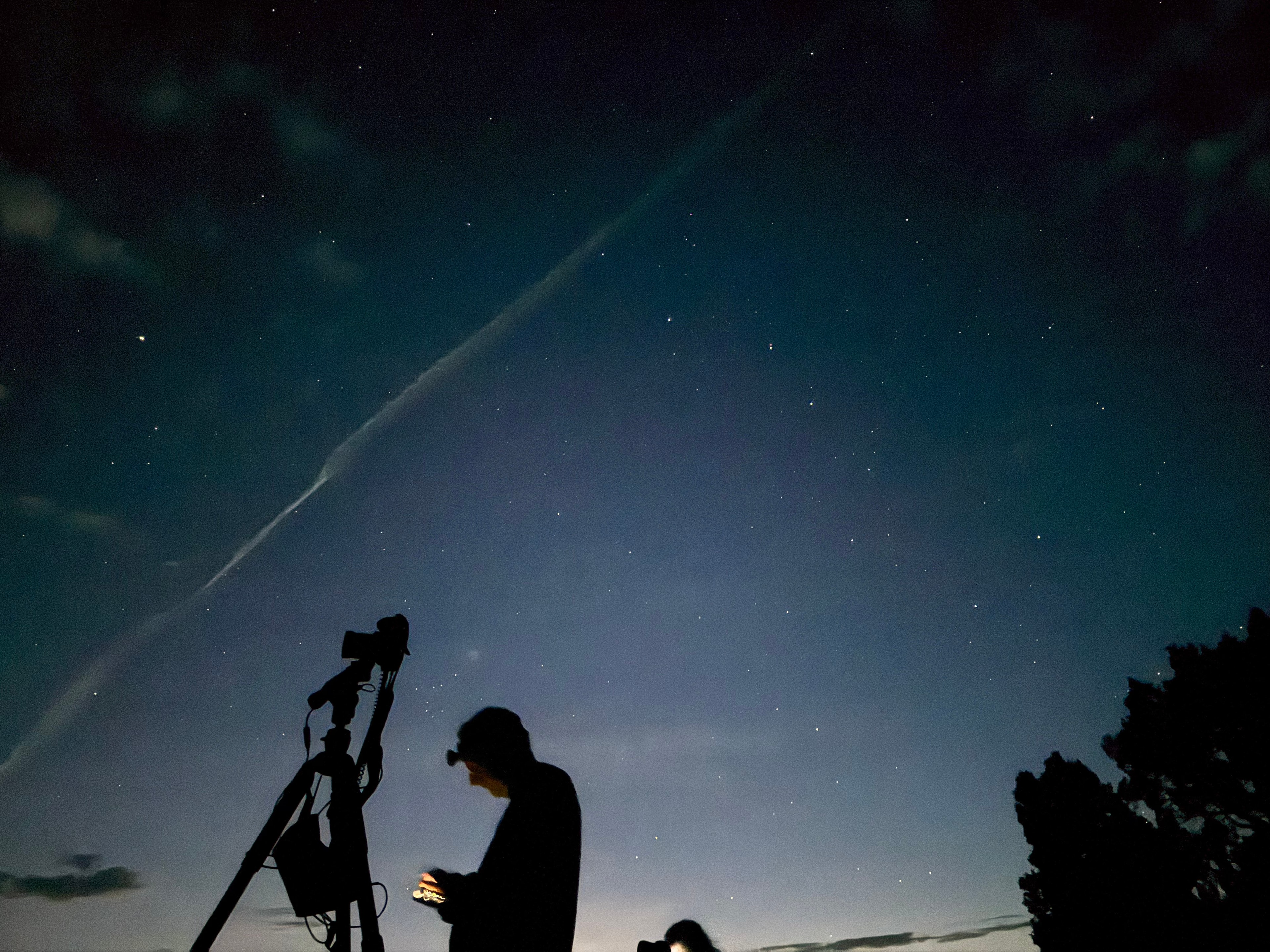 Stargazer with telescope under the night sky in Bluff, Utah